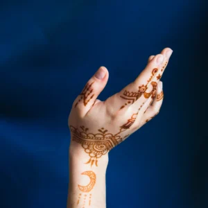 hand-with-mehndi-near-blue-textile